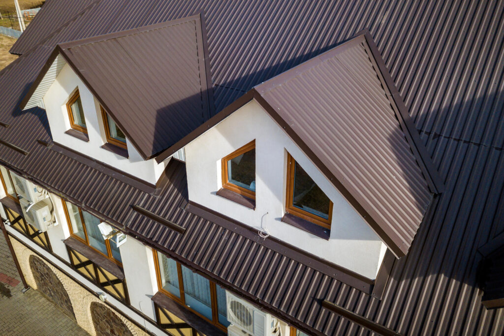 metal roof vs tile roof-brown corrugated metal roof on a house